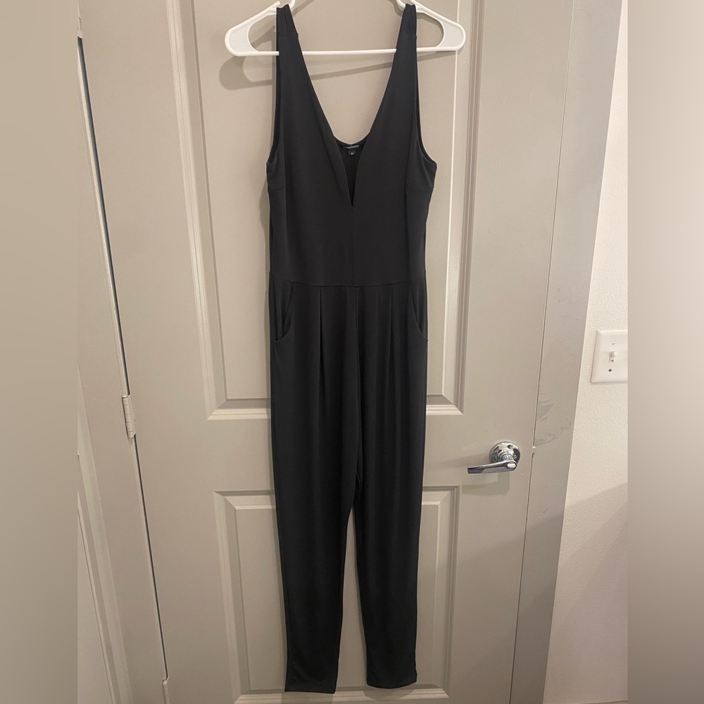 Black jumpsuit with pockets. Tapered leg at bottom. Size M. Super cute!